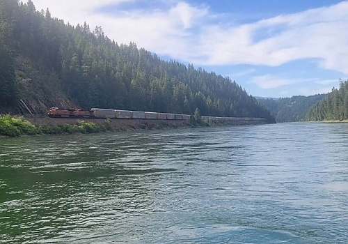  Freight train passing along coast of river