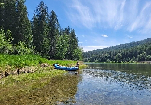 Raft on edge of calm river 