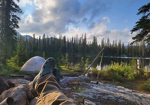  View of pair of feet and campsite in Wyoming